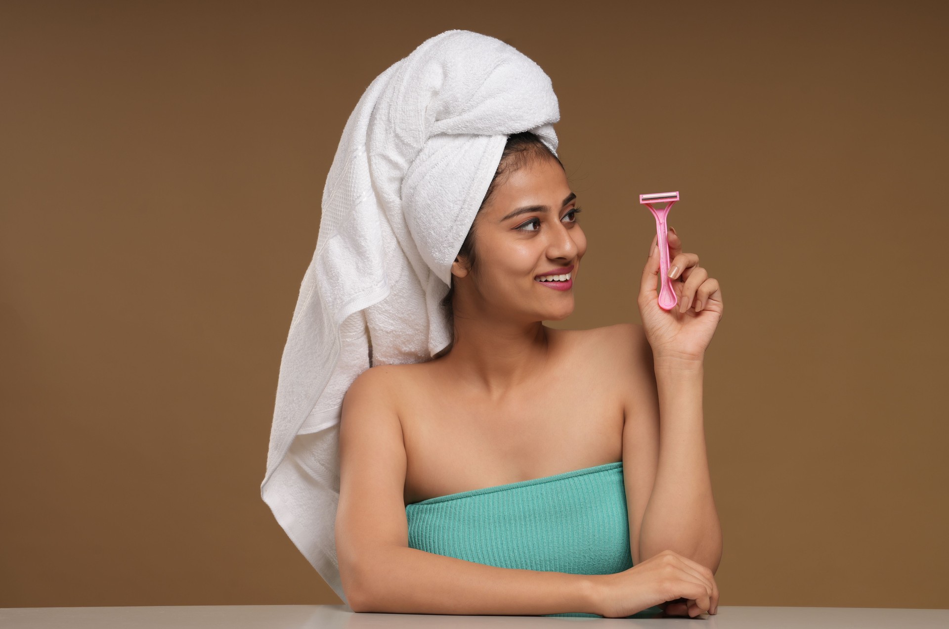 Portraits of a young women holding razor for hair removal